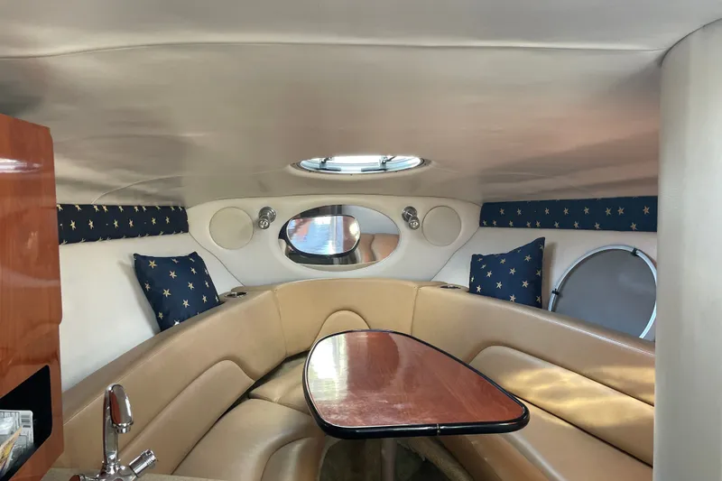 Slide: The Image of Interior of 2012 Crownline 260 CR boat with cozy seating and star-patterned cushions. - 10