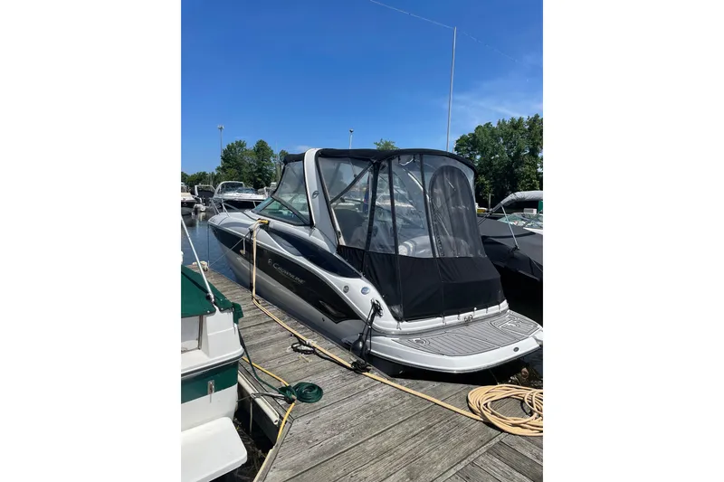 Slide: The Image of 2012 Crownline 260 CR boat docked at marina under clear blue sky. - 22