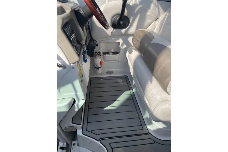Slide: The Image of Interior of 2012 Crownline 260 CR boat with steering wheel and seating area. - 9