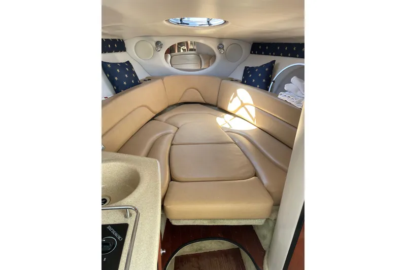 Slide: The Image of Interior of 2012 Crownline 260 CR boat with beige seating and nautical decor. - 12