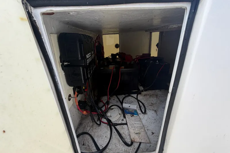 Slide: The Image of Battery compartment of a 2011 Jefferson Marlago FS35 boat, featuring wiring and charger. - 28