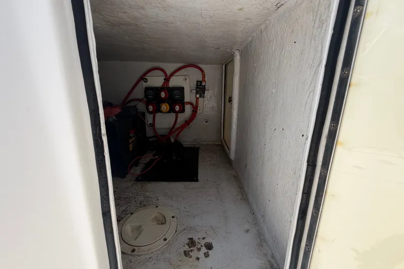 Slide: The Image of Electrical compartment of a 2011 Jefferson Marlago FS35 boat with wiring and battery. - 25