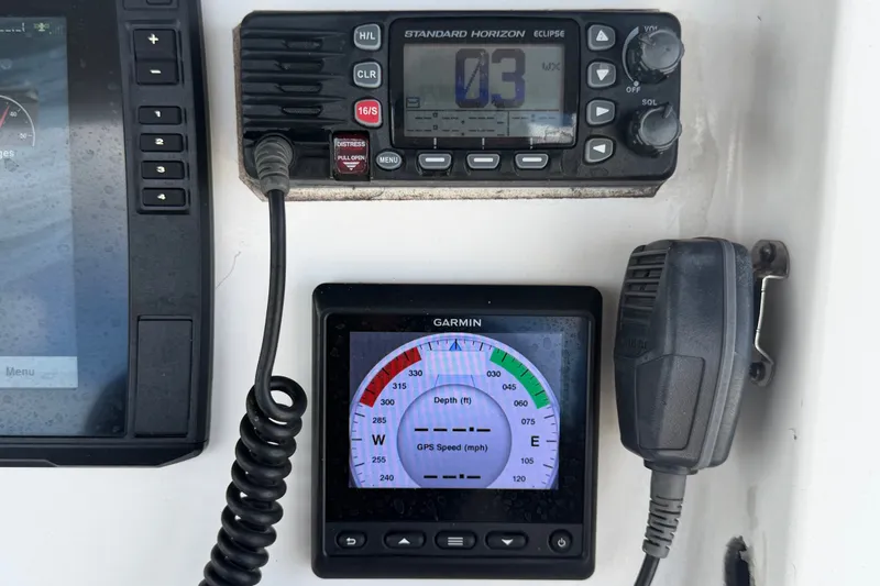 Slide: The Image of Boat dashboard with Garmin GPS and Standard Horizon radio, Jefferson Marlago FS35, 2011 model. - 37