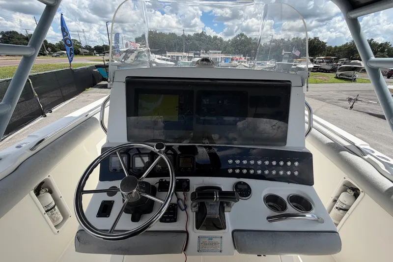 Slide: The Image of Cockpit view of a 2011 Jefferson Marlago FS35 boat with steering wheel and control panel. - 32