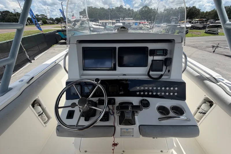 Slide: The Image of 2011 Jefferson Marlago FS35 boat dashboard with steering wheel and navigation controls. - 33