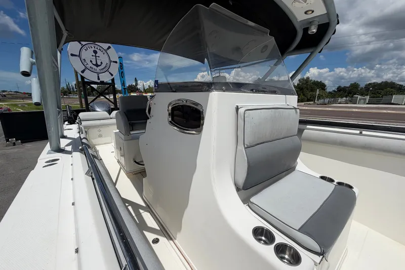 Slide: The Image of 2011 Jefferson Marlago FS35 boat interior with seating and console under a clear sky. - 75