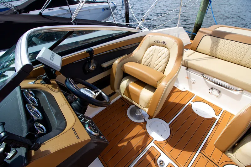 Slide: The Image of The image shows the cockpit of a 2015 Sea Ray 220 Sundeck boat with luxurious seating. - 45