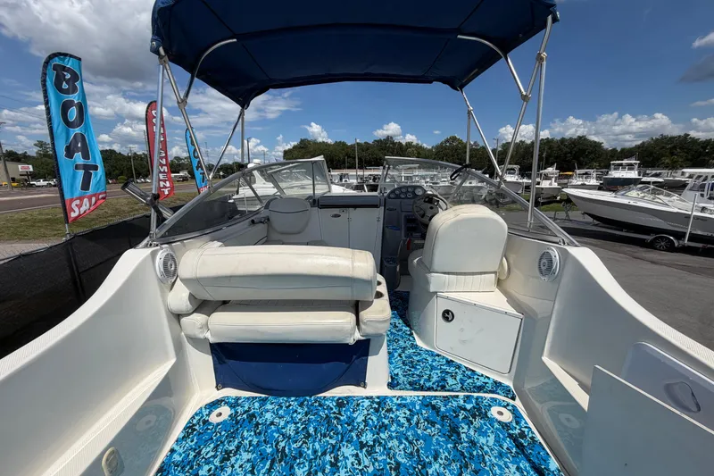 Slide: The Image of 2004 Bayliner 2452 Ciera Express boat interior with blue patterned flooring and canopy. - 13