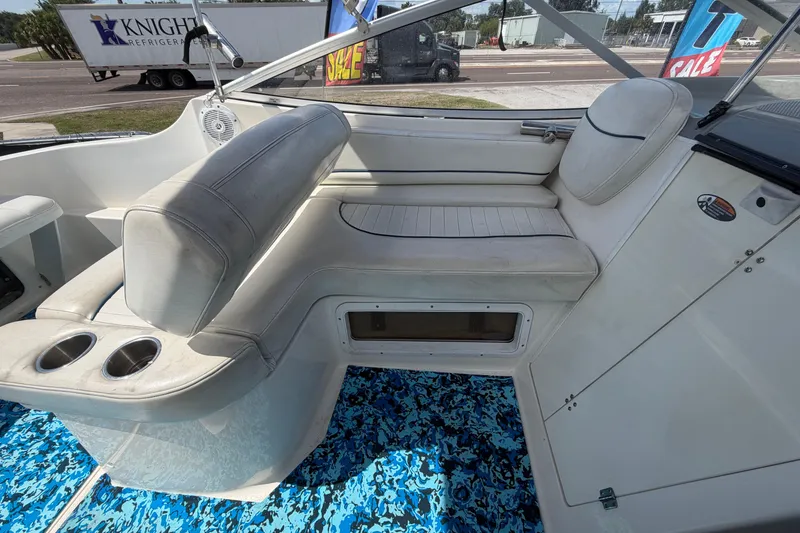 Slide: The Image of 2004 Bayliner 2452 Ciera Express interior with white seating and blue patterned flooring. - 70