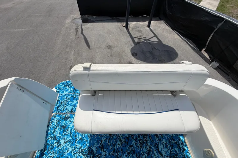 Slide: The Image of 2004 Bayliner 2452 Ciera Express boat with white seating and blue patterned flooring. - 82