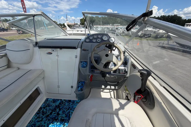 Slide: The Image of 2004 Bayliner 2452 Ciera Express cockpit with steering wheel and control panel. - 22