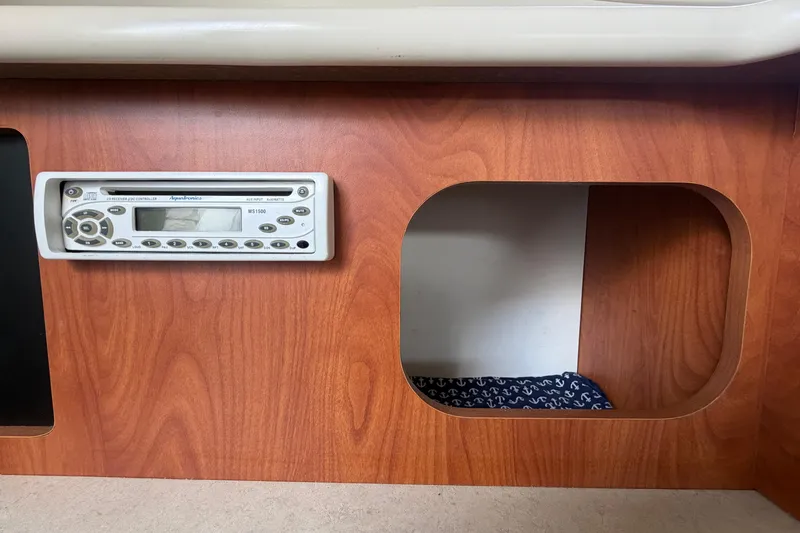 Slide: The Image of 2004 Bayliner 2452 Ciera Express interior with wood paneling and stereo system. - 42