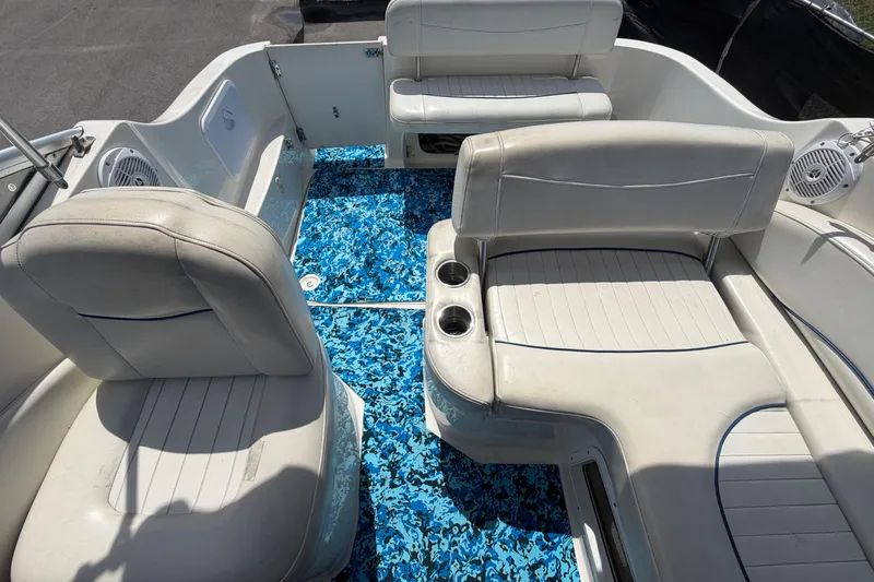Slide: The Image of 2004 Bayliner 2452 Ciera Express boat interior with white seating and blue patterned flooring. - 72