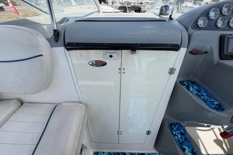 Slide: The Image of 2004 Bayliner 2452 Ciera Express cockpit with seating and control panel details. - 69