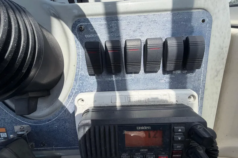 Slide: The Image of Control panel of a 2004 Bayliner 2452 Ciera Express boat with switches and radio. - 26