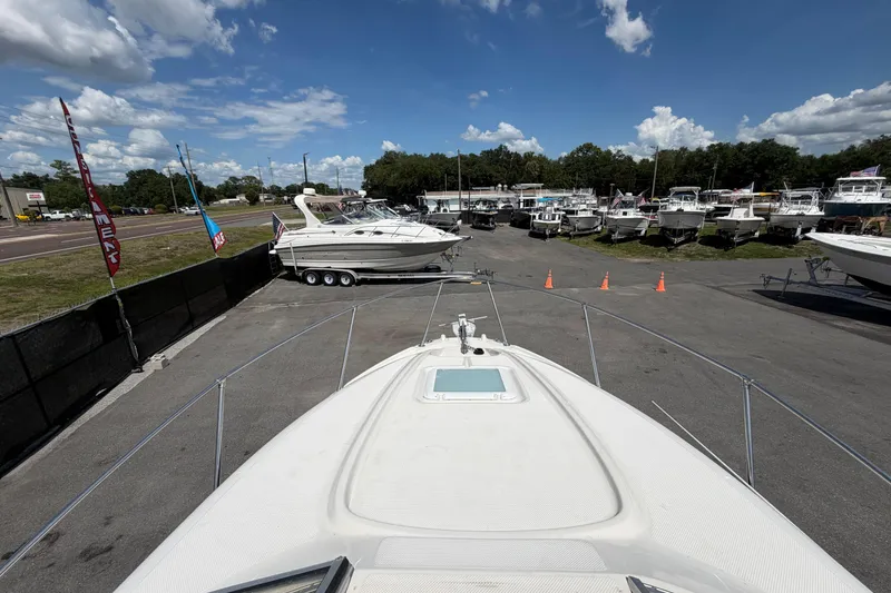 Slide: The Image of 2004 Bayliner 2452 Ciera Express boat at a marina with other vessels. - 61