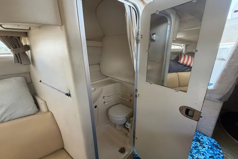 Slide: The Image of 2004 Bayliner 2452 Ciera Express cabin interior with compact bathroom and cozy seating area. - 47