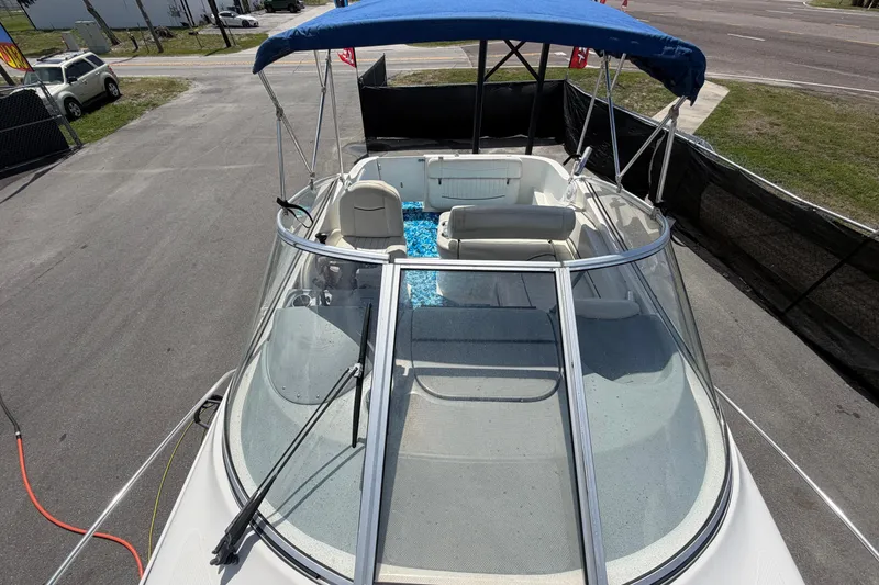 Slide: The Image of 2004 Bayliner 2452 Ciera Express boat with blue canopy and spacious seating area. - 65