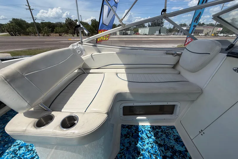 Slide: The Image of 2004 Bayliner 2452 Ciera Express interior with white seating and cup holders. - 71
