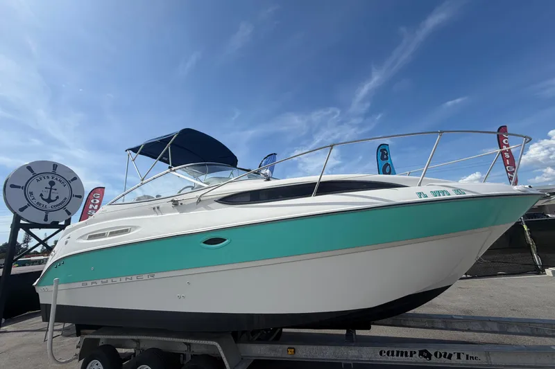 The Image of 2004 Bayliner 2452 Ciera Express boat on trailer under clear blue sky. - 0