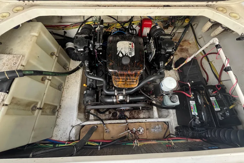 Slide: The Image of Engine compartment of a 2004 Bayliner 2452 Ciera Express boat, showcasing wiring and components. - 76