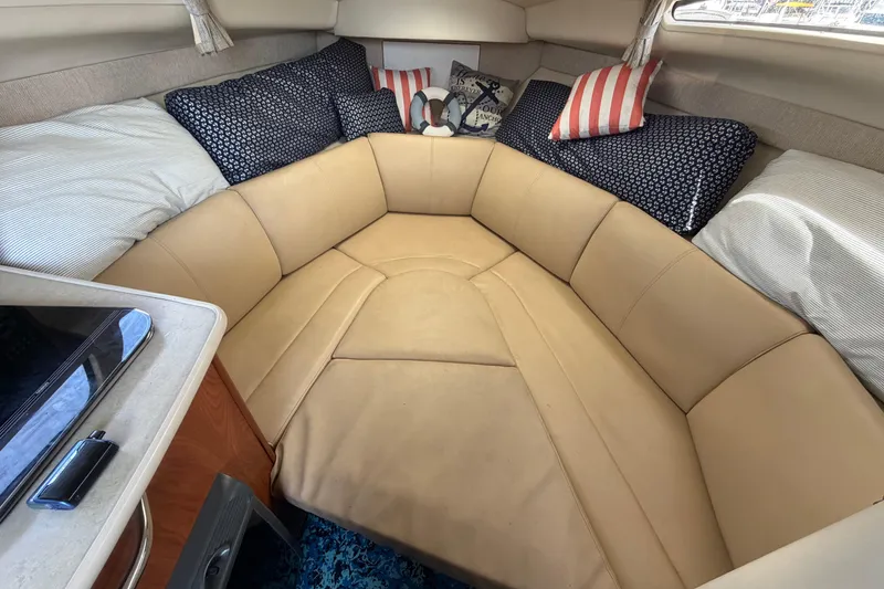 Slide: The Image of 2004 Bayliner 2452 Ciera Express cabin with cozy seating and decorative pillows. - 34
