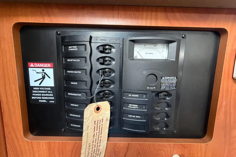 Slide: The Image of Electrical panel of a 2004 Bayliner 2452 Ciera Express with voltage meter and safety warning. - 39