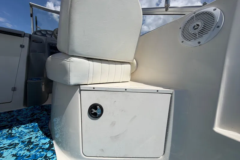 Slide: The Image of 2004 Bayliner 2452 Ciera Express interior with white seating and Kenwood speaker. - 18