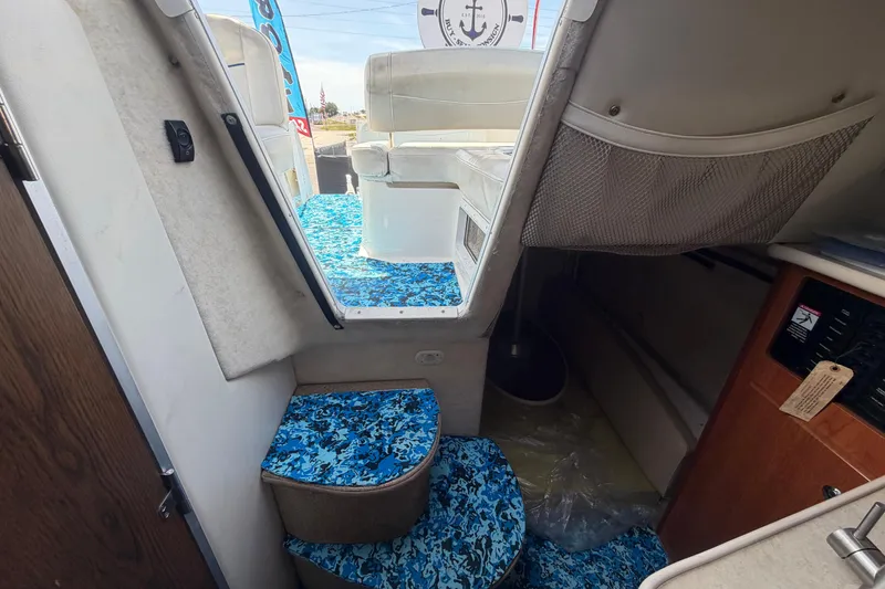 Slide: The Image of Interior view of 2004 Bayliner 2452 Ciera Express with blue patterned flooring. - 56