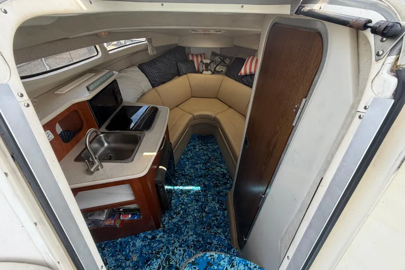Slide: The Image of Interior of 2004 Bayliner 2452 Ciera Express with kitchenette and seating area. - 29