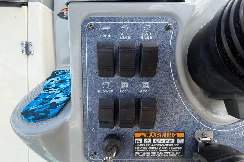 Slide: The Image of Control panel of a 2004 Bayliner 2452 Ciera Express boat with switches and warning label. - 25