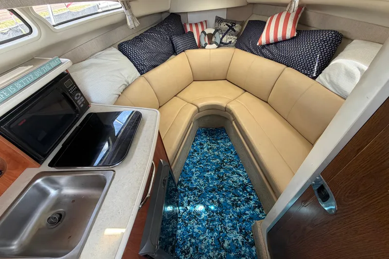 Slide: The Image of Interior of 2004 Bayliner 2452 Ciera Express with cozy seating and kitchenette. - 32