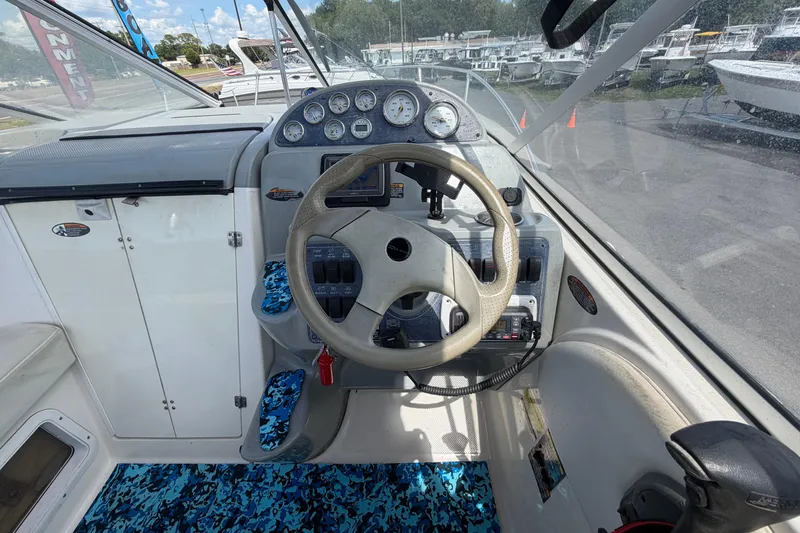 Slide: The Image of 2004 Bayliner 2452 Ciera Express helm with steering wheel and instrument panel. - 23