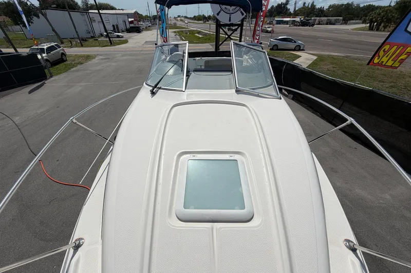 Slide: The Image of 2004 Bayliner 2452 Ciera Express boat deck view at a sales lot. - 64