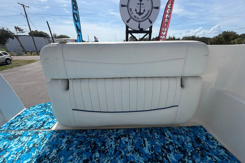 Slide: The Image of 2004 Bayliner 2452 Ciera Express boat seat with blue patterned flooring. - 78