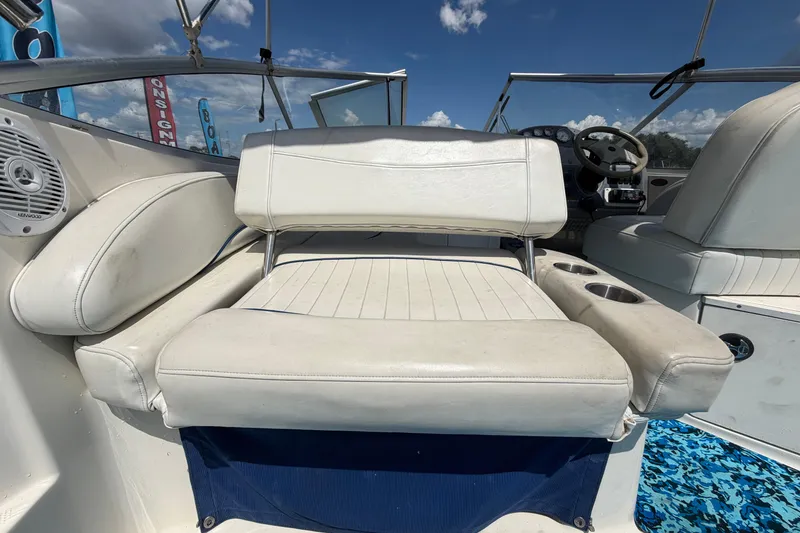 Slide: The Image of 2004 Bayliner 2452 Ciera Express boat interior with white seating and steering wheel. - 15