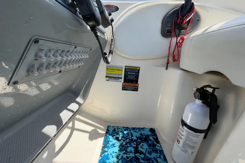 Slide: The Image of Control panel and safety equipment on a 2004 Bayliner 2452 Ciera Express boat. - 27