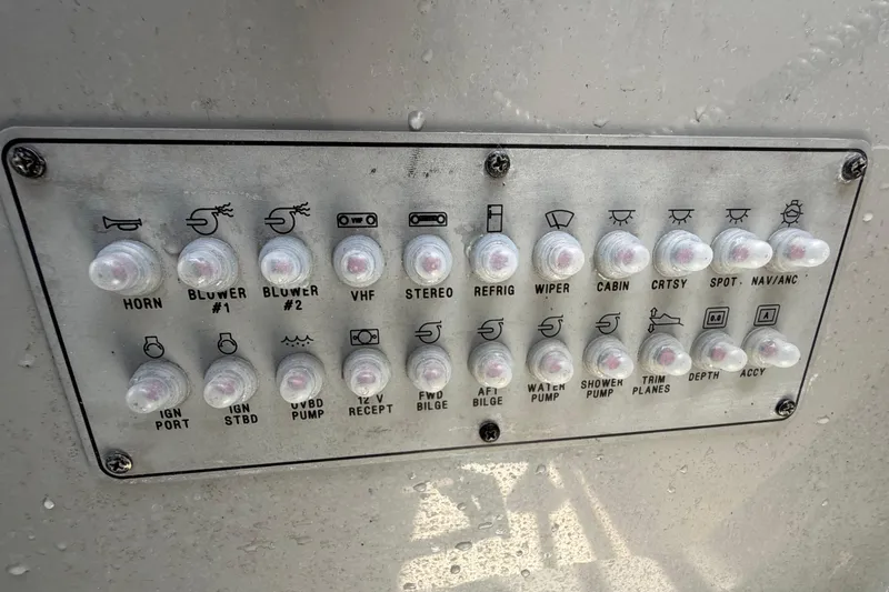Slide: The Image of Control panel of a 2004 Bayliner 2452 Ciera Express boat with labeled switches. - 28