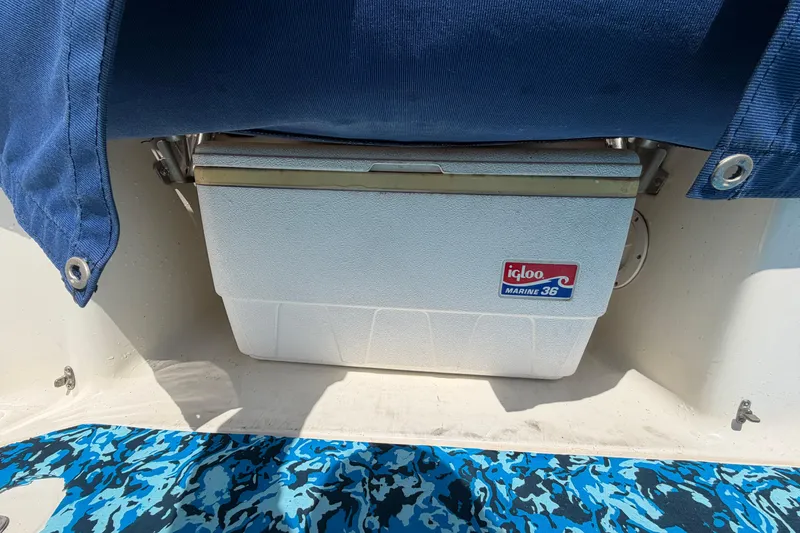 Slide: The Image of Igloo Marine cooler on 2004 Bayliner 2452 Ciera Express boat with blue fabric cover. - 16