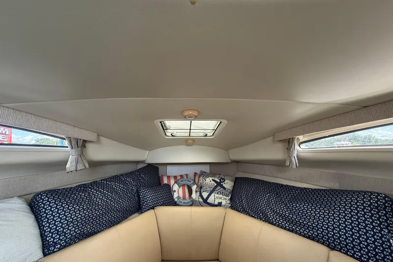 Slide: The Image of Interior cabin of 2004 Bayliner 2452 Ciera Express with cozy seating and nautical decor. - 37
