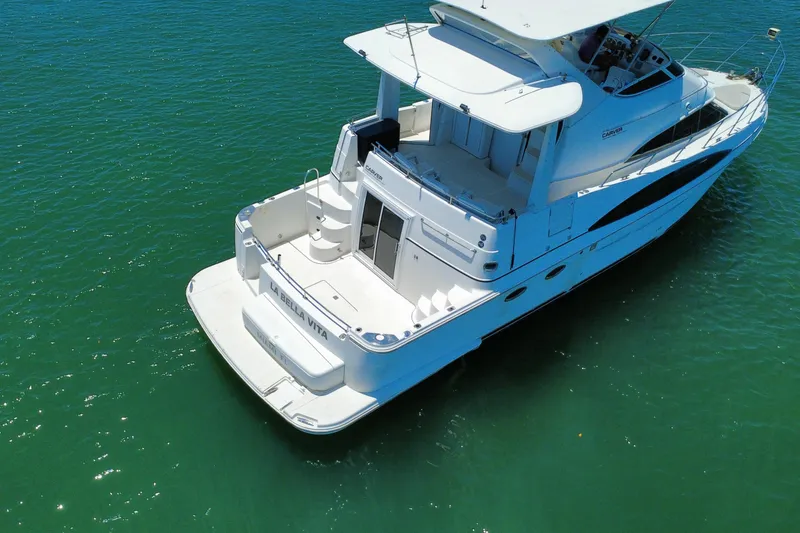 Slide: The Image of 2004 Carver 444 Cockpit Motor Yacht on clear blue water. - 13