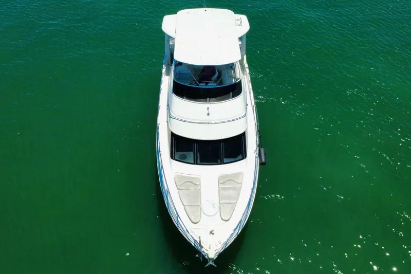 Slide: The Image of Top view of a 2004 Carver 444 Cockpit Motor Yacht on green water. - 16