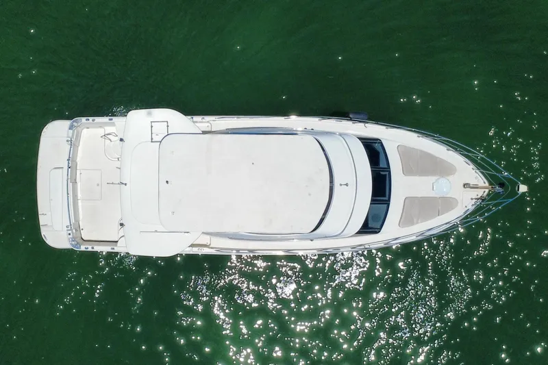Slide: The Image of Aerial view of 2004 Carver 444 Cockpit Motor Yacht on green water. - 14