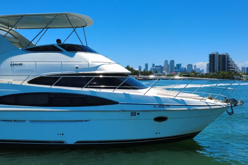 Slide: The Image of 2004 Carver 444 Cockpit Motor Yacht cruising near city skyline on a sunny day. - 17