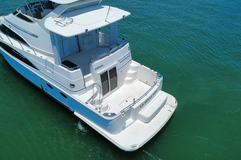 Slide: The Image of 2004 Carver 444 Cockpit Motor Yacht on calm water, rear view. - 15