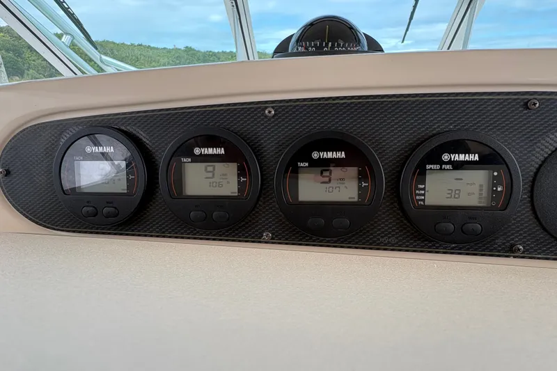 Slide: The Image of Yamaha gauges on 2007 Grady-White Express 360 boat dashboard, displaying speed and fuel data. - 17