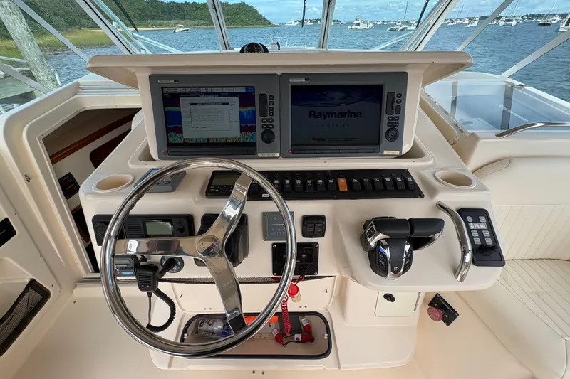 Slide: The Image of 2007 Grady-White Express 360 helm with dual Raymarine displays and steering wheel. - 16