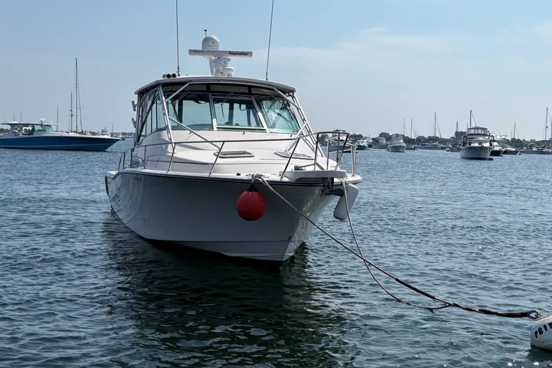 Slide: The Image of 2007 Grady-White Express 360 boat moored in a calm harbor with other vessels. - 4