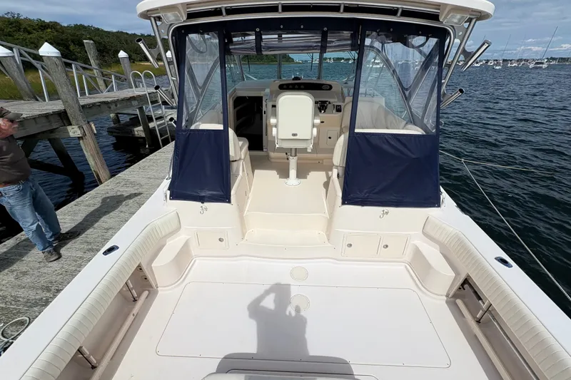 Slide: The Image of 2007 Grady-White Express 360 boat docked, featuring spacious deck and helm area. - 32