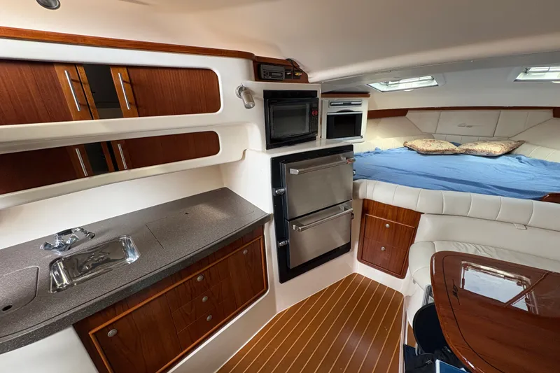 Slide: The Image of Luxurious 2007 Grady-White Express 360 cabin interior with kitchenette and cozy sleeping area. - 24